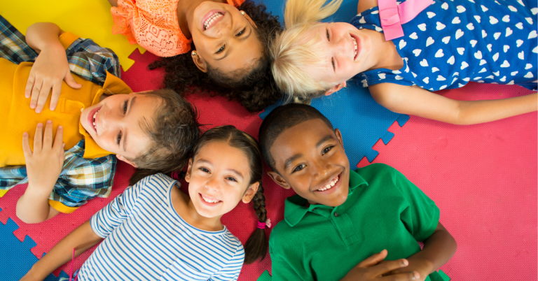 Children smiling together in an early years setting